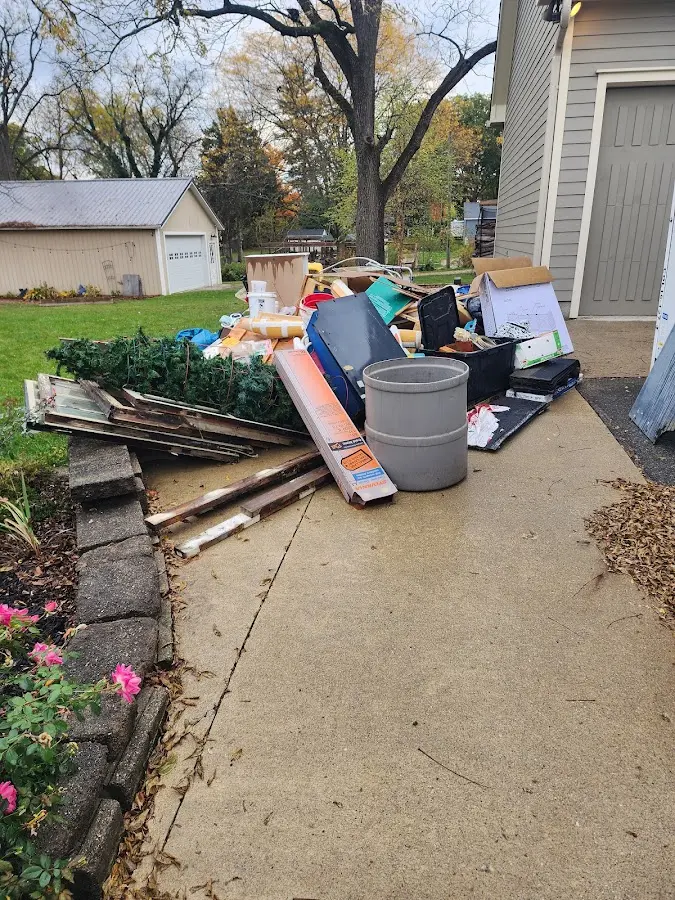 Dumpster being loaded with debris for 12 Yard Dumpster Rental in Cleburne